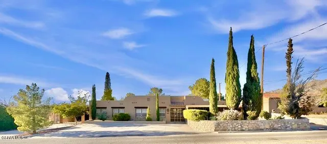 a street sign on a sidewalk next to a road