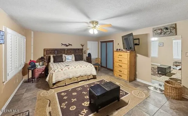 a bedroom with a bed dresser and a window