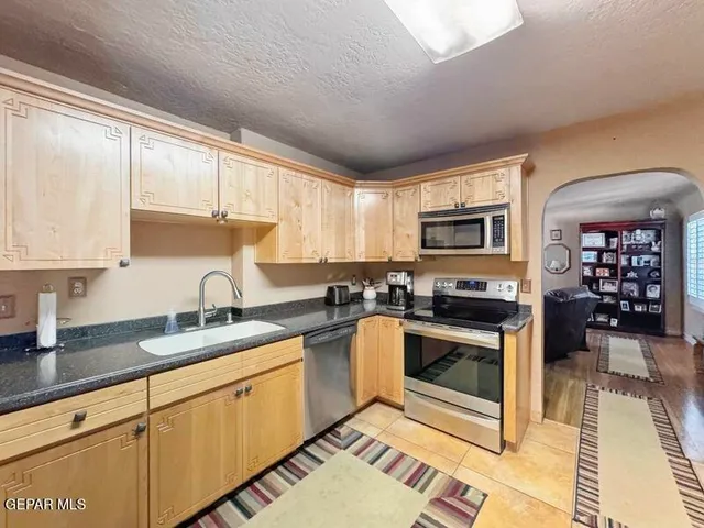 a kitchen with a sink stove and cabinets