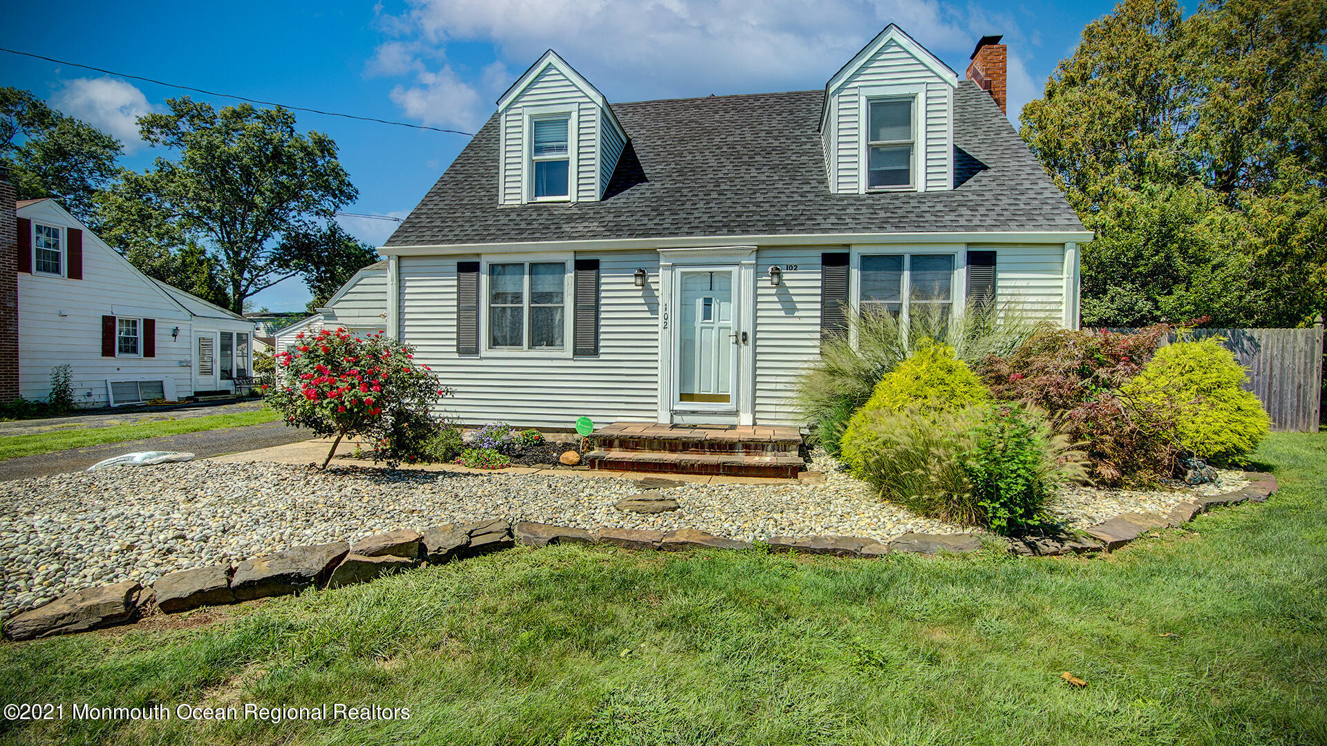 a front view of a house with garden