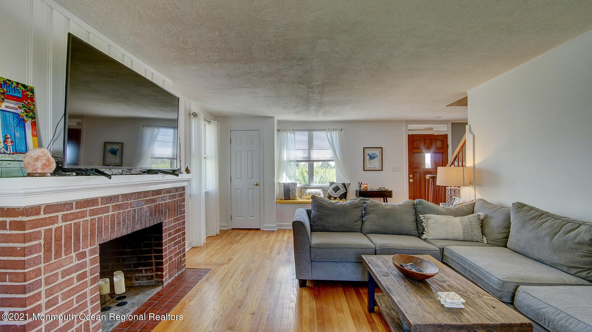 102 Wilburtha Road Ewing, NJ 08628 - Photo 11 of 30 a living room with furniture a fireplace and a flat screen tv