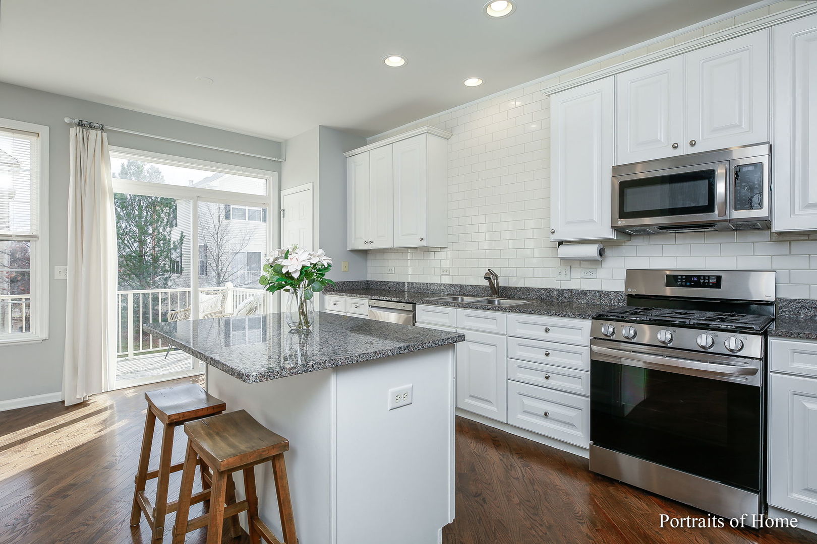126 Jackson Street Gilberts, IL 60136 - Photo 6 of 25 a kitchen with stainless steel appliances granite countertop a stove a sink and a microwave