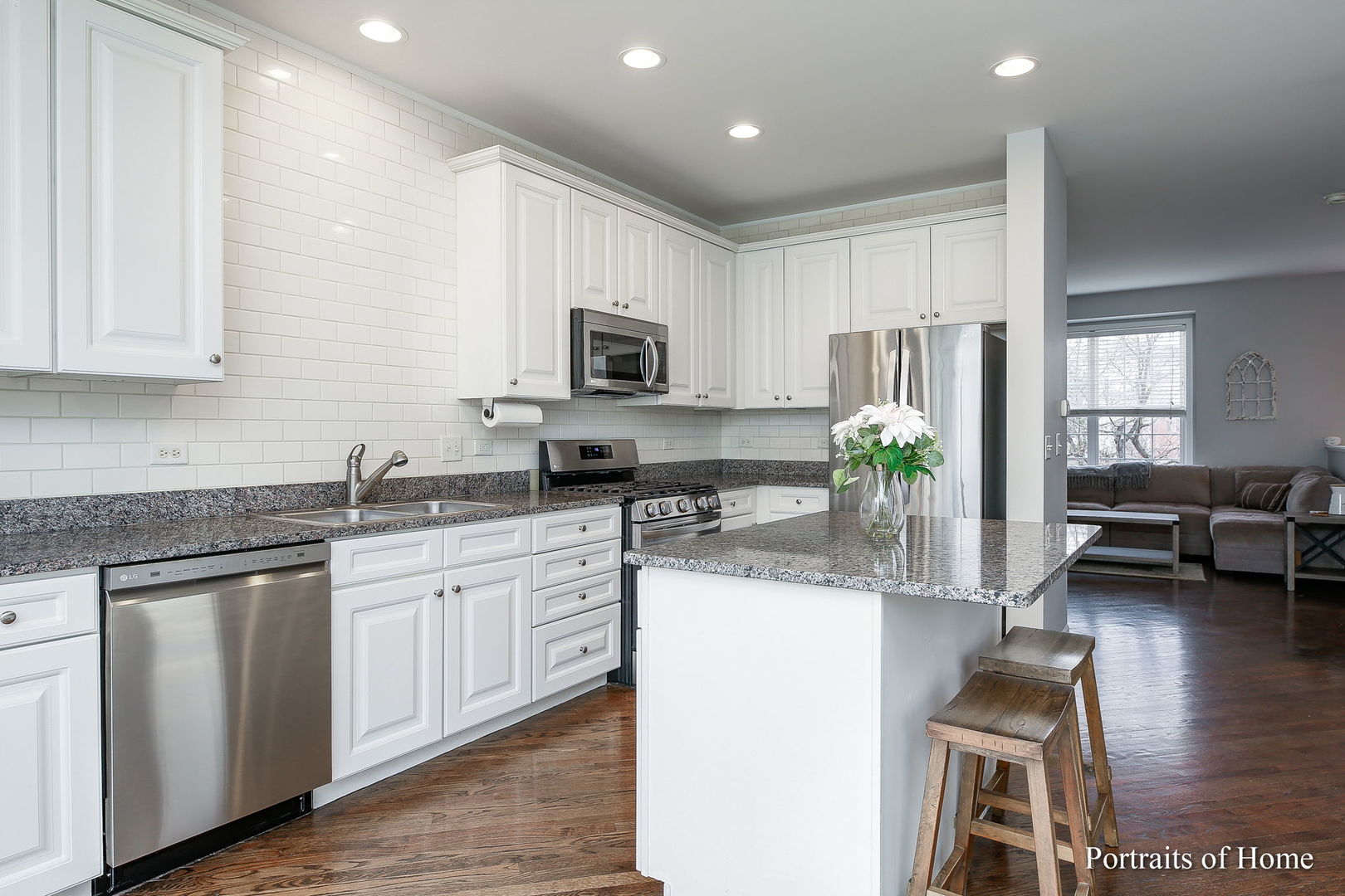 126 Jackson Street Gilberts, IL 60136 - Photo 8 of 25 a kitchen with kitchen island granite countertop stainless steel appliances stove a sink and a refrigerator