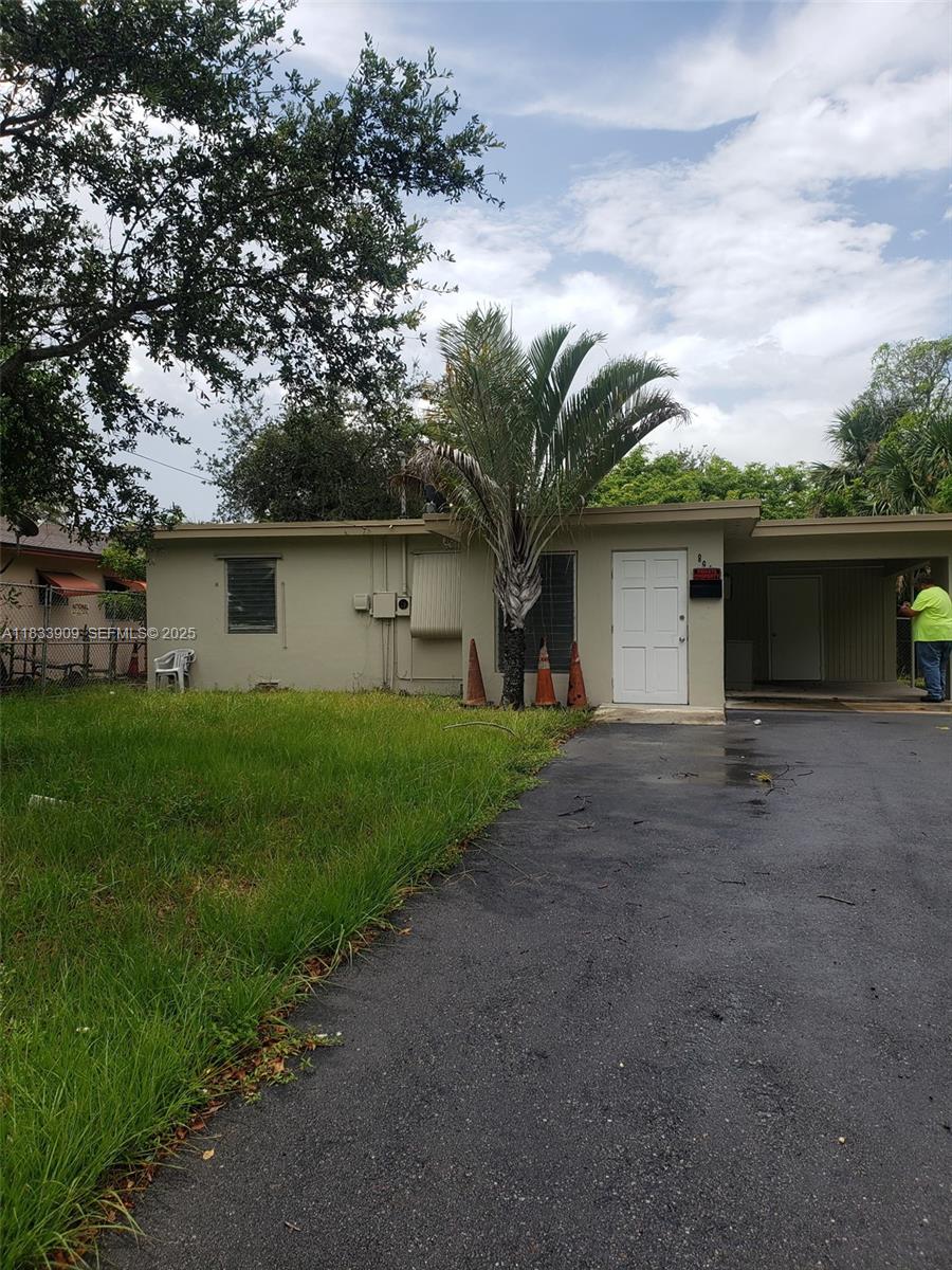 894 Southwest 9th Court Pompano Beach, FL 33060 - Photo 2 of 4 a front view of house with yard and trees