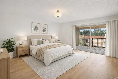 a bedroom with a large bed and a large window