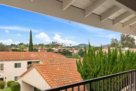 a view of a balcony with yard