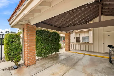a view of a porch with furniture and floor to ceiling window