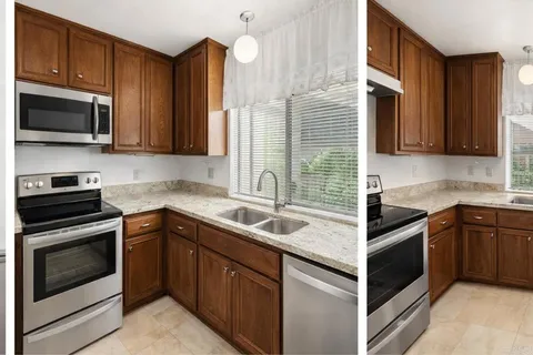 a kitchen with stainless steel appliances granite countertop a sink stove and microwave