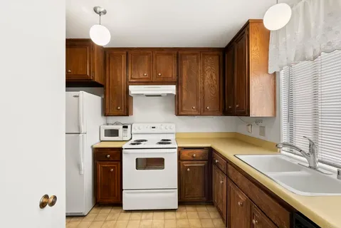 a kitchen with a sink cabinets and appliances