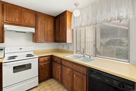 a kitchen with a sink stove and cabinets