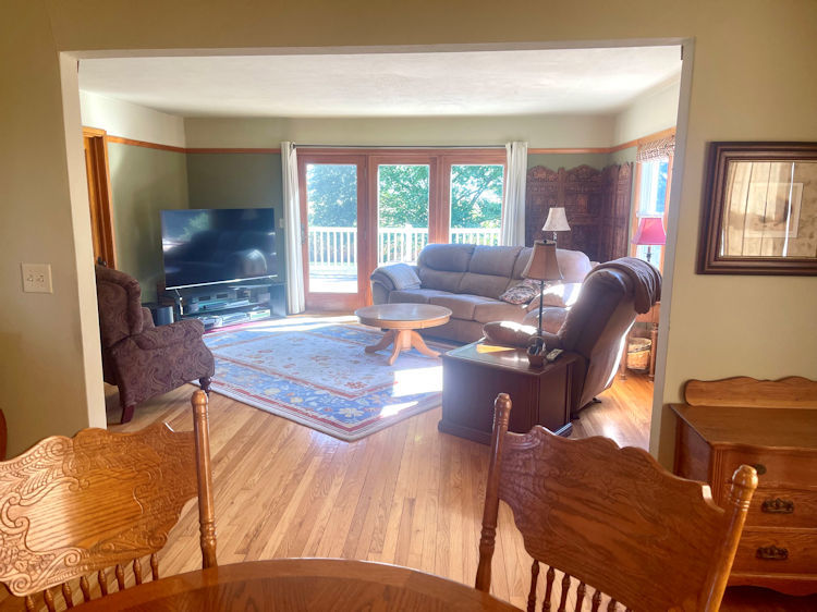 906 South Chamberlain Road Esmond, IL 60129 - Photo 5 of 19 a living room with furniture a flat screen tv and a floor to ceiling window