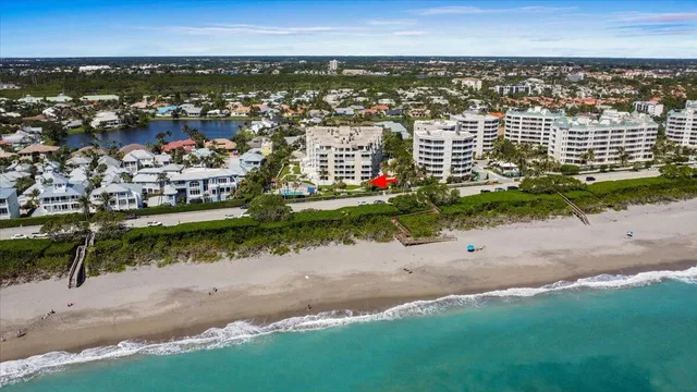 a front view of a house with a yard and fountain