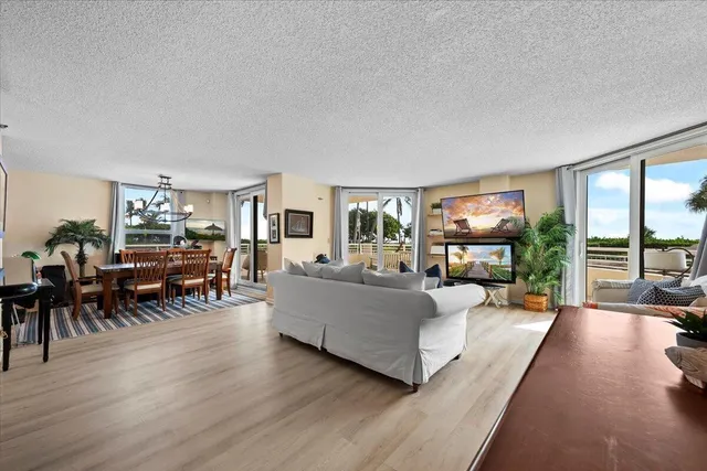a living room with furniture and a flat screen tv with wooden floor