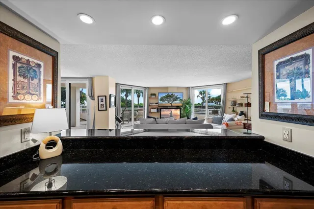 a kitchen with stainless steel appliances granite countertop a stove a microwave and a refrigerator