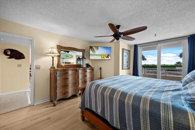 a bedroom with bed and wooden floor