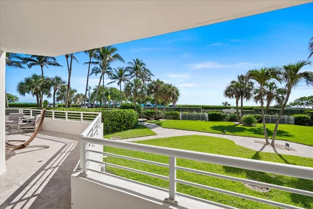 a balcony with table and chairs
