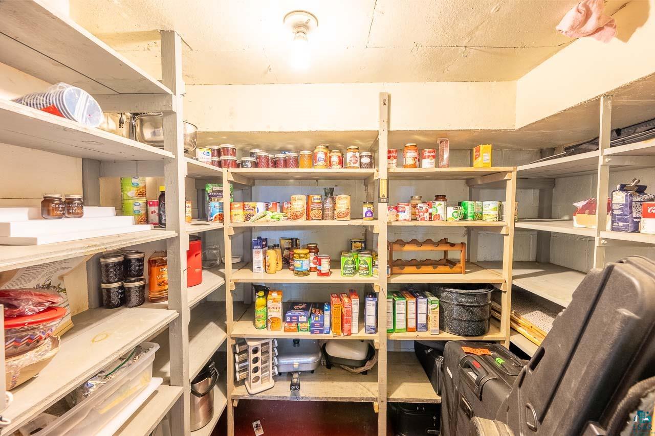 101 2nd Avenue North Biwabik, MN 55708 - Photo 33 of 44 Utility room featuring extensive built-in shelving, overhead lighting, and abundant storage capacity