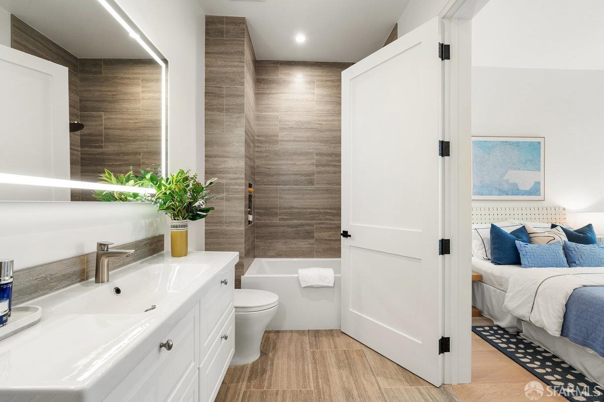 150 Eureka Street, Unit A San Francisco, CA 94114 - Photo 23 of 60 a spacious bathroom with a granite countertop sink a toilet and shower