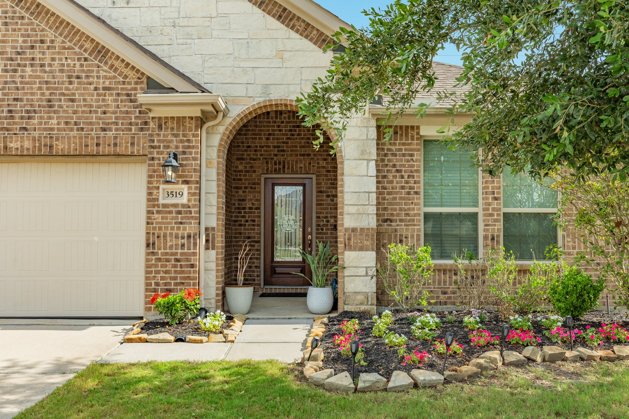3519 Bay Drive Rosharon, TX 77583 - Photo 2 of 49 Upon entering, you are welcomed by a stunning wood and glass front door that opens onto a covered porch, beautifully integrated into the surrounding natural landscape.