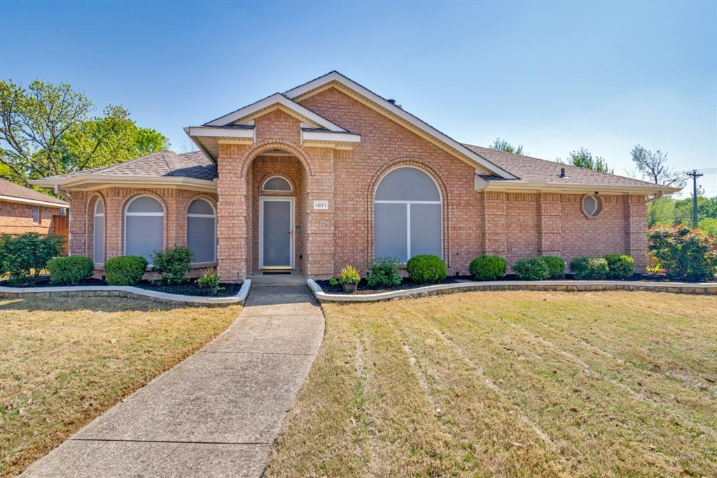 View of front of home featuring a front lawn and brick siding