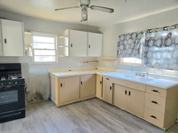 a view of a kitchen with a sink a window and stainless steel appliances