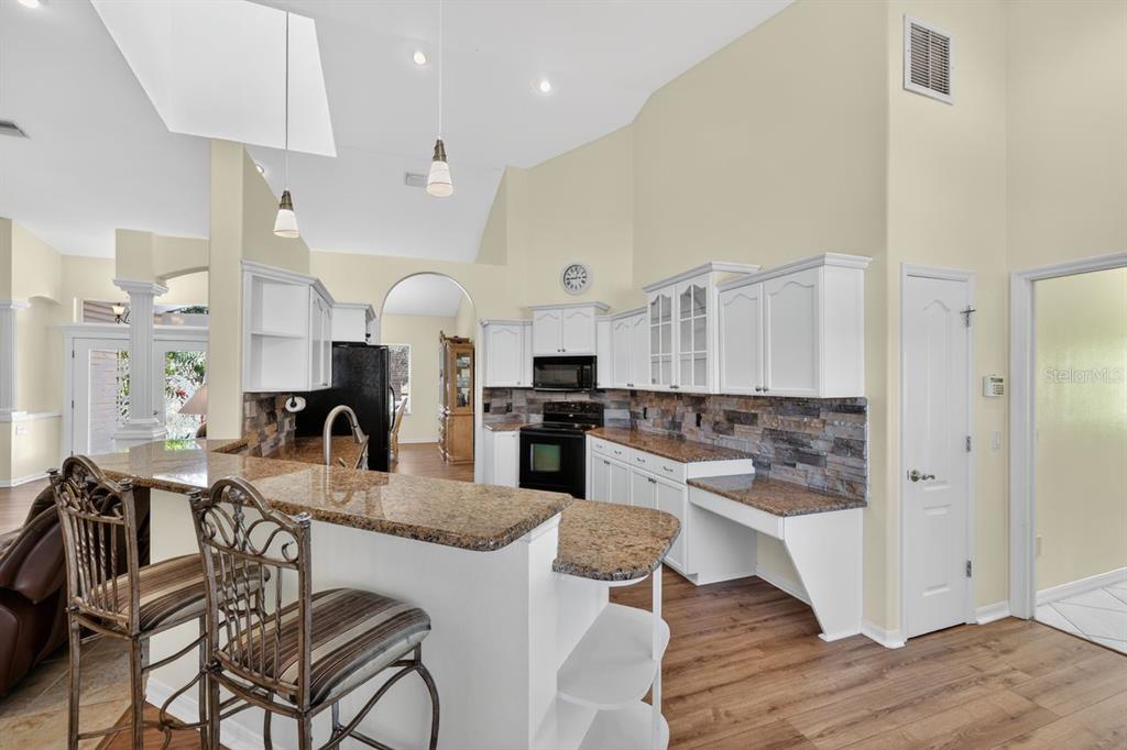 17312 Howling Wolf Run Parrish, FL 34219 - Photo 12 of 41 a large kitchen with a table and chairs