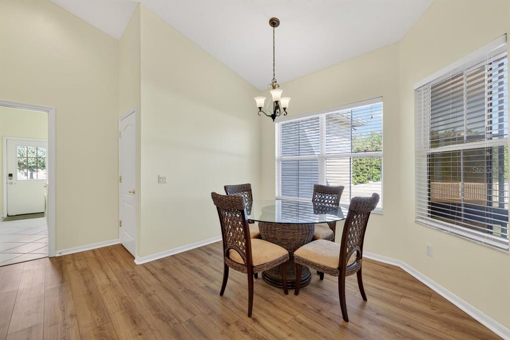 17312 Howling Wolf Run Parrish, FL 34219 - Photo 14 of 41 a view of a dining room with furniture window and wooden floor