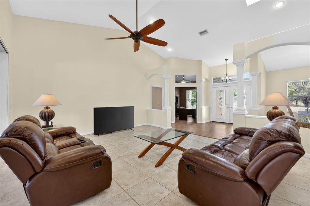 17312 Howling Wolf Run Parrish, FL 34219 - Photo 7 of 41 a living room with furniture and a flat screen tv