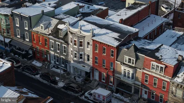 a front view of a building with sitting area