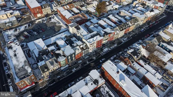 a view of patio with a table and chairs and potted plants