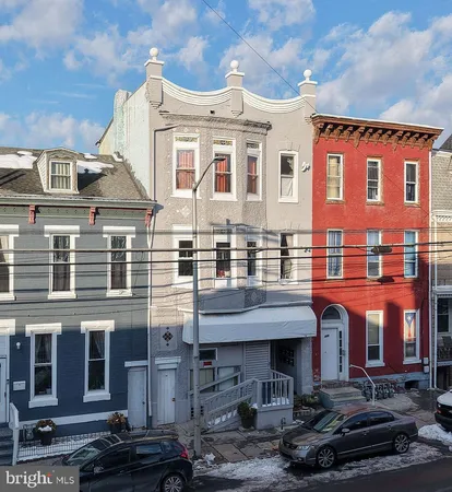 a front view of a residential apartment building with a yard