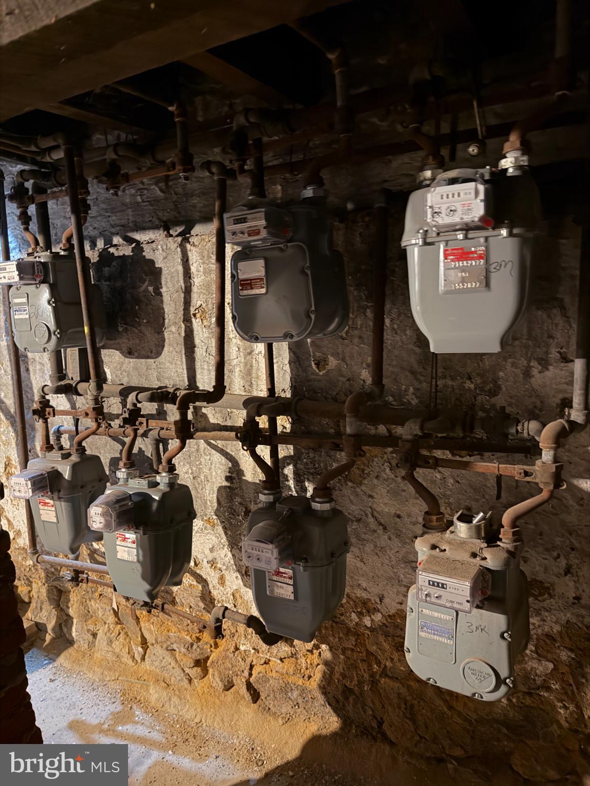 226 North 10th Street Reading, PA 19601 - Photo 31 of 56 Utility meters in a rustic basement setting.