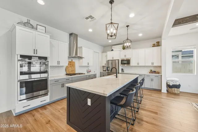 a large kitchen with a table and chairs