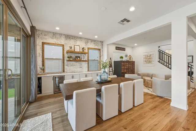 a very nice looking living room with stainless steel appliances granite countertop furniture a fireplace and a window