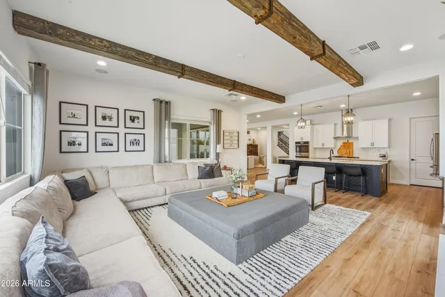 a living room with furniture kitchen view and a table