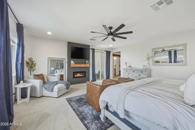 a spacious bedroom with a large bed and a fireplace