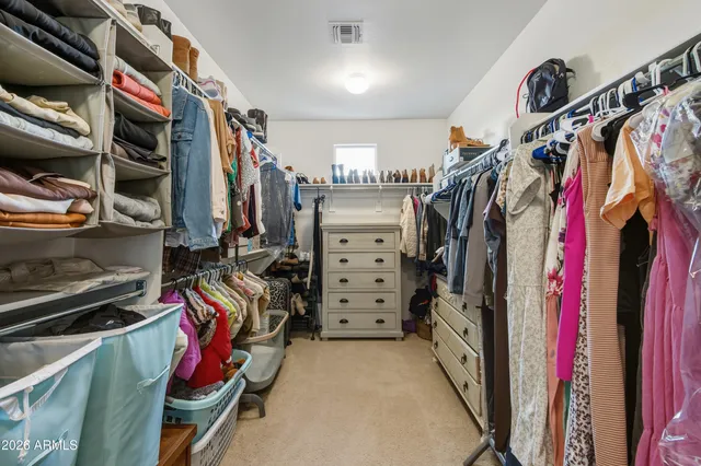 a view of walk in closet with clothes