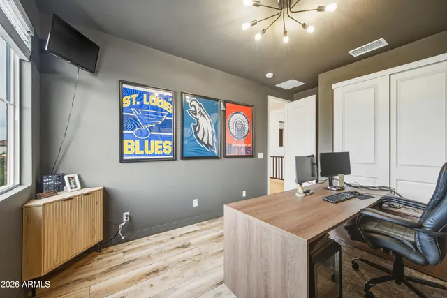 a view of a workspace with furniture and a window