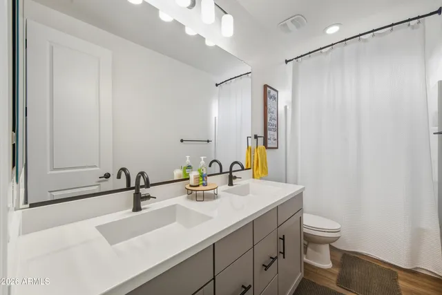 a bathroom with a sink double vanity and a mirror