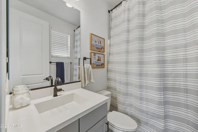 a bathroom with a sink toilet and mirror