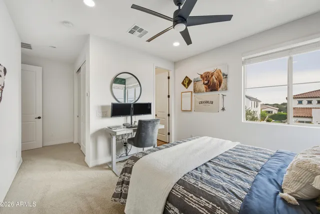 a bedroom with a large bed and a chandelier