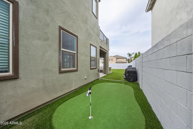 a view of a backyard both side of the house