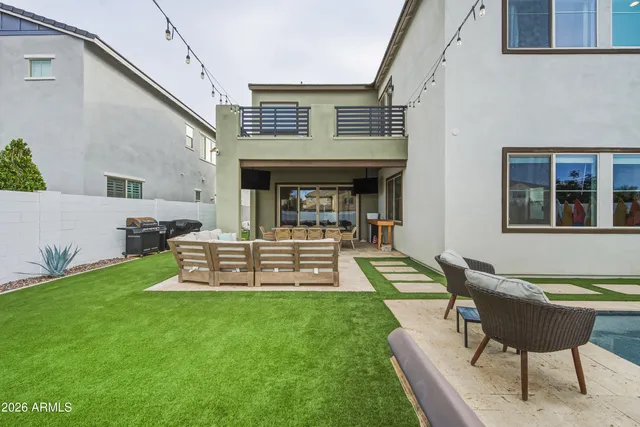 a view of an house with backyard porch and sitting area