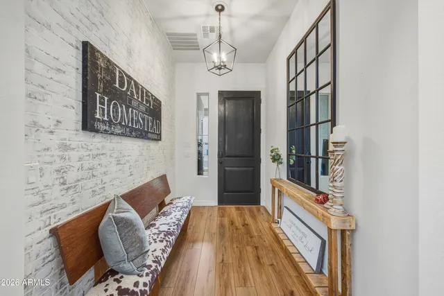 a hallway with furniture and wooden floor