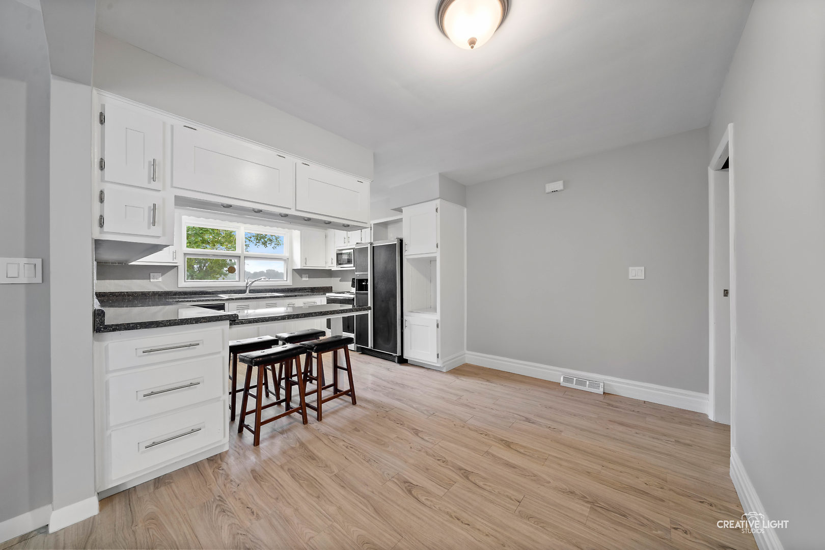 1255 North Randall Road Aurora, IL 60506 - Photo 13 of 39 a kitchen with stainless steel appliances a stove a refrigerator and wooden floor