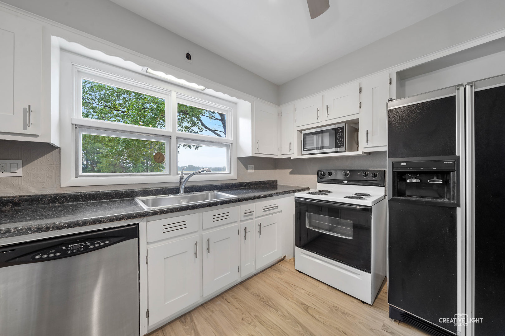 1255 North Randall Road Aurora, IL 60506 - Photo 17 of 39 a kitchen with granite countertop a sink stainless steel appliances and window
