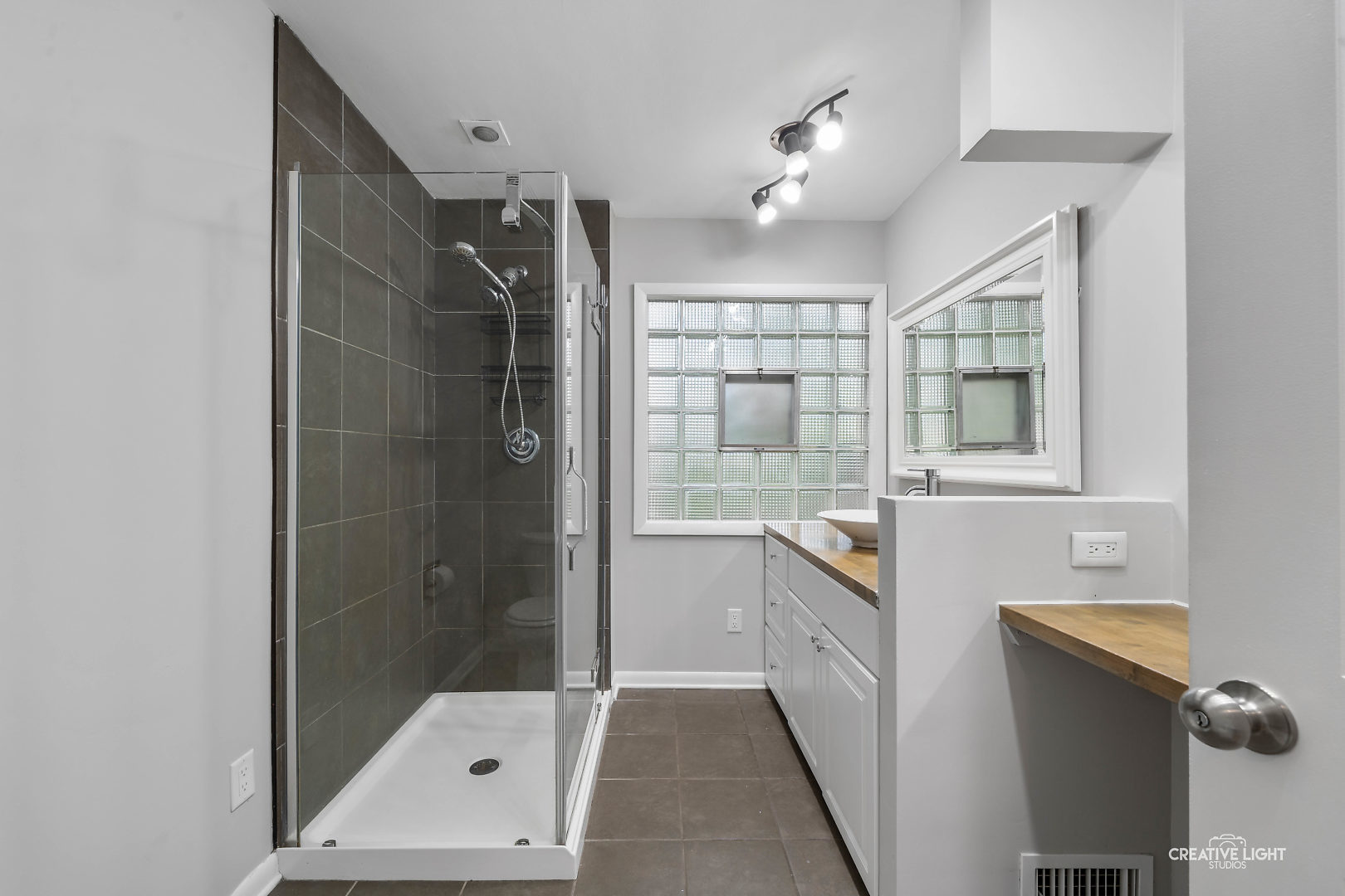 1255 North Randall Road Aurora, IL 60506 - Photo 19 of 39 a bathroom with a shower sink and mirror