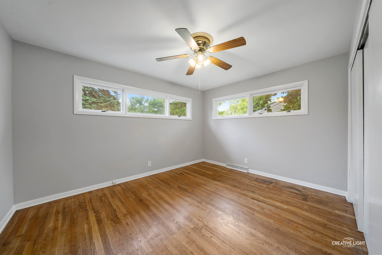 1255 North Randall Road Aurora, IL 60506 - Photo 21 of 39 a view of an empty room with wooden floor and a window