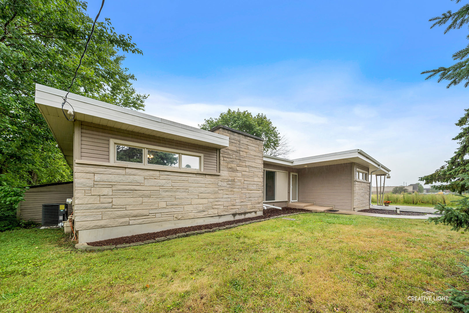 1255 North Randall Road Aurora, IL 60506 - Photo 6 of 39 a front view of house with yard and trees in the background