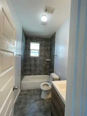 a bathroom with a bathtub toilet and sink